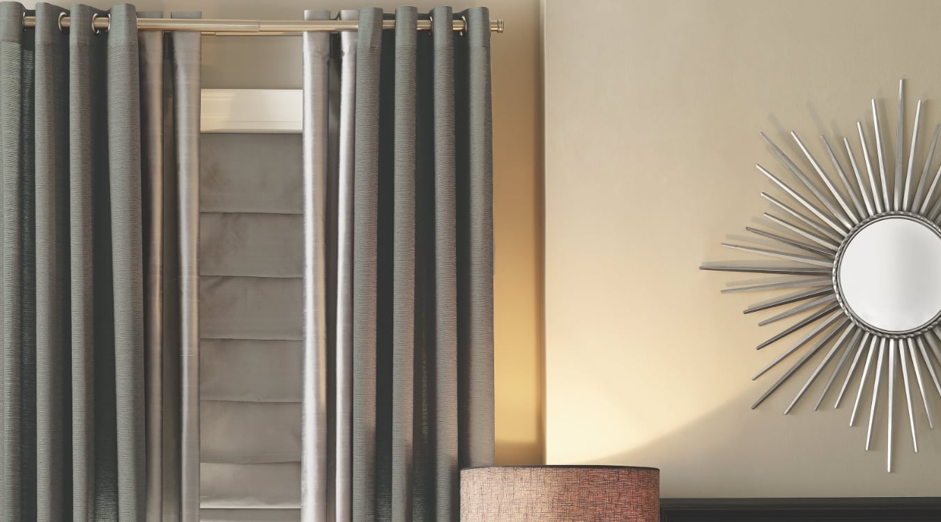 Roman shades are a great choice when you want increased privacy. Roman shutters layered with curtains.